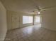Open-concept living room with tile flooring, large windows, and natural lighting at 4795 Via San Andros, Las Vegas, NV 89103