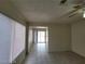 Living room with tiled floors and sliding door access to an enclosed patio at 4795 Via San Andros, Las Vegas, NV 89103