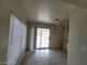 Living room with tiled floors and sliding door access to an enclosed patio at 4795 Via San Andros, Las Vegas, NV 89103