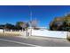 Exterior view of a single story home with a large white security gate at 4928 E Monroe Ave, Las Vegas, NV 89110