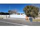 Exterior view of a single story home featuring a long, white security gate at 4928 E Monroe Ave, Las Vegas, NV 89110