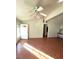 Bright living room featuring a ceiling fan, tile flooring, and convenient access to other parts of the home at 4928 E Monroe Ave, Las Vegas, NV 89110
