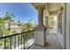 A charming balcony with stone columns offers neighborhood views and wrought iron railings at 52 Cascade Lake St, Las Vegas, NV 89148
