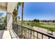 Balcony view showcasing the nearby lush golf course and palm trees against a clear blue sky at 52 Cascade Lake St, Las Vegas, NV 89148