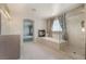 Lavish bathroom featuring a soaking tub with a fireplace and glass shower at 52 Cascade Lake St, Las Vegas, NV 89148