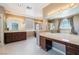 Bright bathroom with dual vanities, makeup vanity, glass shower, and soaking tub at 52 Cascade Lake St, Las Vegas, NV 89148