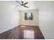 Bedroom with hardwood floors, ceiling fan, and large window with natural light at 52 Cascade Lake St, Las Vegas, NV 89148