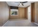 Neutral bedroom with a ceiling fan, window, and walk-in closet at 52 Cascade Lake St, Las Vegas, NV 89148