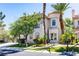 Charming two-story home with a stucco exterior, barrel tile roof, and lush desert landscaping at 52 Cascade Lake St, Las Vegas, NV 89148