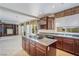 Gourmet kitchen with island cooktop, custom cabinetry, and a view of the Gathering room at 52 Cascade Lake St, Las Vegas, NV 89148