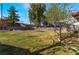 Lush backyard with mature trees, a trampoline, and well-maintained grass for outdoor enjoyment at 5221 Holmby Ave, Las Vegas, NV 89146