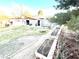 Expansive backyard featuring a storage shed and garden beds, perfect for outdoor projects at 5221 Holmby Ave, Las Vegas, NV 89146