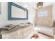 Well-lit bathroom featuring a tub, toilet, large vanity, and mosaic tile accent wall at 5221 Holmby Ave, Las Vegas, NV 89146