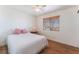 Bright bedroom with hardwood floors, ceiling fan, and natural light from large window at 5221 Holmby Ave, Las Vegas, NV 89146