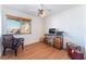 Cozy bedroom with wood floors, desk, chair, ceiling fan and good natural light at 5221 Holmby Ave, Las Vegas, NV 89146