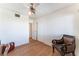 Spacious bedroom with wood floors, accent chair, closet, and a large, bright window at 5221 Holmby Ave, Las Vegas, NV 89146