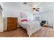 This bedroom features hardwood floors, a ceiling fan, and a large window for natural light at 5221 Holmby Ave, Las Vegas, NV 89146