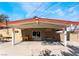 Relax on this covered patio with modern lighting, a dining set, and easy access to the backyard at 5221 Holmby Ave, Las Vegas, NV 89146