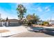 Inviting single-story house with mature trees and an attached garage at 5221 Holmby Ave, Las Vegas, NV 89146