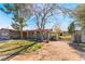 Quaint single-story home with a lush lawn and driveway leading to a detached garage at 5221 Holmby Ave, Las Vegas, NV 89146