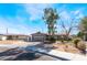 Cozy single-story home with an attached garage and a well-maintained front yard at 5221 Holmby Ave, Las Vegas, NV 89146