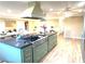 The kitchen features a large island with a gas cooktop and seamless flow to the dining area at 5221 Holmby Ave, Las Vegas, NV 89146