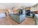 Spacious kitchen features an expansive island, custom cabinets and stainless appliances at 5221 Holmby Ave, Las Vegas, NV 89146