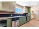 The kitchen features stainless appliances and ample counter space with a bright window at 5221 Holmby Ave, Las Vegas, NV 89146