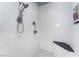 Modern shower featuring white tile, black and white tile floors, and a built-in seat at 5221 Holmby Ave, Las Vegas, NV 89146