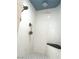 Contemporary shower with white tile, black and white mosaic floors, and sleek fixtures at 5221 Holmby Ave, Las Vegas, NV 89146