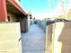 Gated side yard featuring a concrete pathway, offering privacy and secure access to the property at 5221 Holmby Ave, Las Vegas, NV 89146