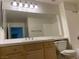 Bathroom featuring a large mirror, vanity with cabinets, and standard fixtures at 5250 S Rainbow Blvd # 1010, Las Vegas, NV 89118