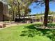 Community dog park area featuring mature shade trees, fencing, and seating at 5250 S Rainbow Blvd # 1010, Las Vegas, NV 89118