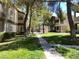 Exterior view of a well-manicured lawn and sidewalks between multiple apartment buildings at 5250 S Rainbow Blvd # 1010, Las Vegas, NV 89118