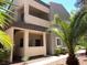 Exterior of an apartment building with balconies, desert landscaping, and unit number on the door at 5250 S Rainbow Blvd # 1010, Las Vegas, NV 89118