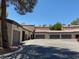 Exterior of multiple garages with a wide, paved driveway and desert landscaping at 5250 S Rainbow Blvd # 1010, Las Vegas, NV 89118