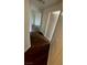 Hallway with dark wood-style floors and neutral walls leading to other rooms at 5250 S Rainbow Blvd # 1010, Las Vegas, NV 89118