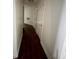Hallway featuring dark wood-style floors, neutral walls, and various access doors at 5250 S Rainbow Blvd # 1010, Las Vegas, NV 89118