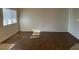 Open living room area featuring wood laminate flooring and a bright window at 5250 S Rainbow Blvd # 1010, Las Vegas, NV 89118