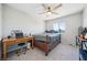 Bright bedroom with light walls, ceiling fan, and a bed beneath the window at 5628 Ridgeland St, North Las Vegas, NV 89031