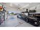 Well organized garage with a sleek black sports car parked inside at 5628 Ridgeland St, North Las Vegas, NV 89031