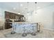Modern kitchen featuring stainless steel appliances, a granite countertop island with seating, and ample cabinet space at 5628 Ridgeland St, North Las Vegas, NV 89031