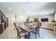 Open-concept living and dining area with tile flooring, modern lighting, and a seamless flow at 5628 Ridgeland St, North Las Vegas, NV 89031