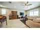 Spacious living room with wood-look tile flooring, ceiling fan, and comfortable sectional couch at 5628 Ridgeland St, North Las Vegas, NV 89031