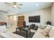 Cozy living room featuring a large sectional sofa, entertainment center, and hardwood flooring at 5628 Ridgeland St, North Las Vegas, NV 89031