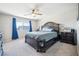 Main bedroom features large bed, ceiling fan, and comfortable atmosphere at 5628 Ridgeland St, North Las Vegas, NV 89031