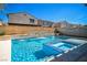 Relaxing backyard pool with a waterfall feature and integrated jacuzzi, surrounded by tasteful landscaping at 5628 Ridgeland St, North Las Vegas, NV 89031