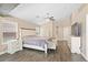 Bright main bedroom with wood floors, ceiling fan, and ensuite bathroom with double sink vanity at 5908 Amber Station Ave, Las Vegas, NV 89131