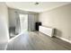 Bright bedroom features new flooring, base trim, modern curtains and balcony door at 6250 W Flamingo Rd # 103, Las Vegas, NV 89103