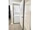 Laundry room showcasing a stacked washer and dryer and a white door at 6250 W Flamingo Rd # 103, Las Vegas, NV 89103